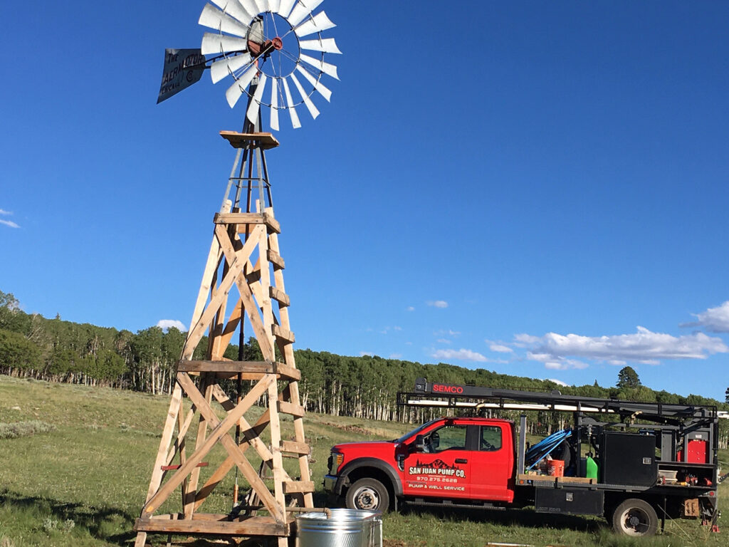 San Juan Pump work truck near windmill